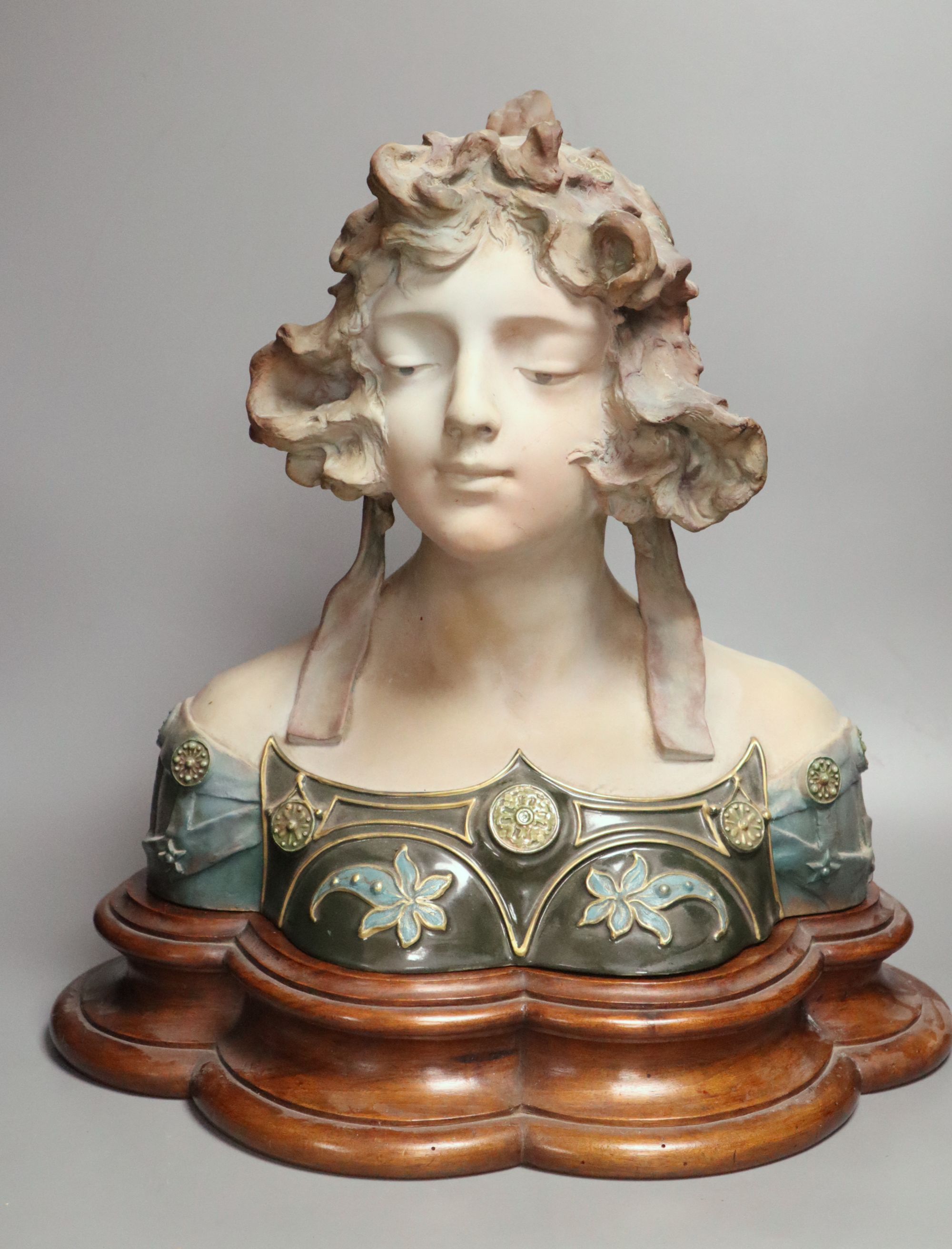 A pottery bust of a lady on a wooden stand, signed Jacobs, overall height 45cm